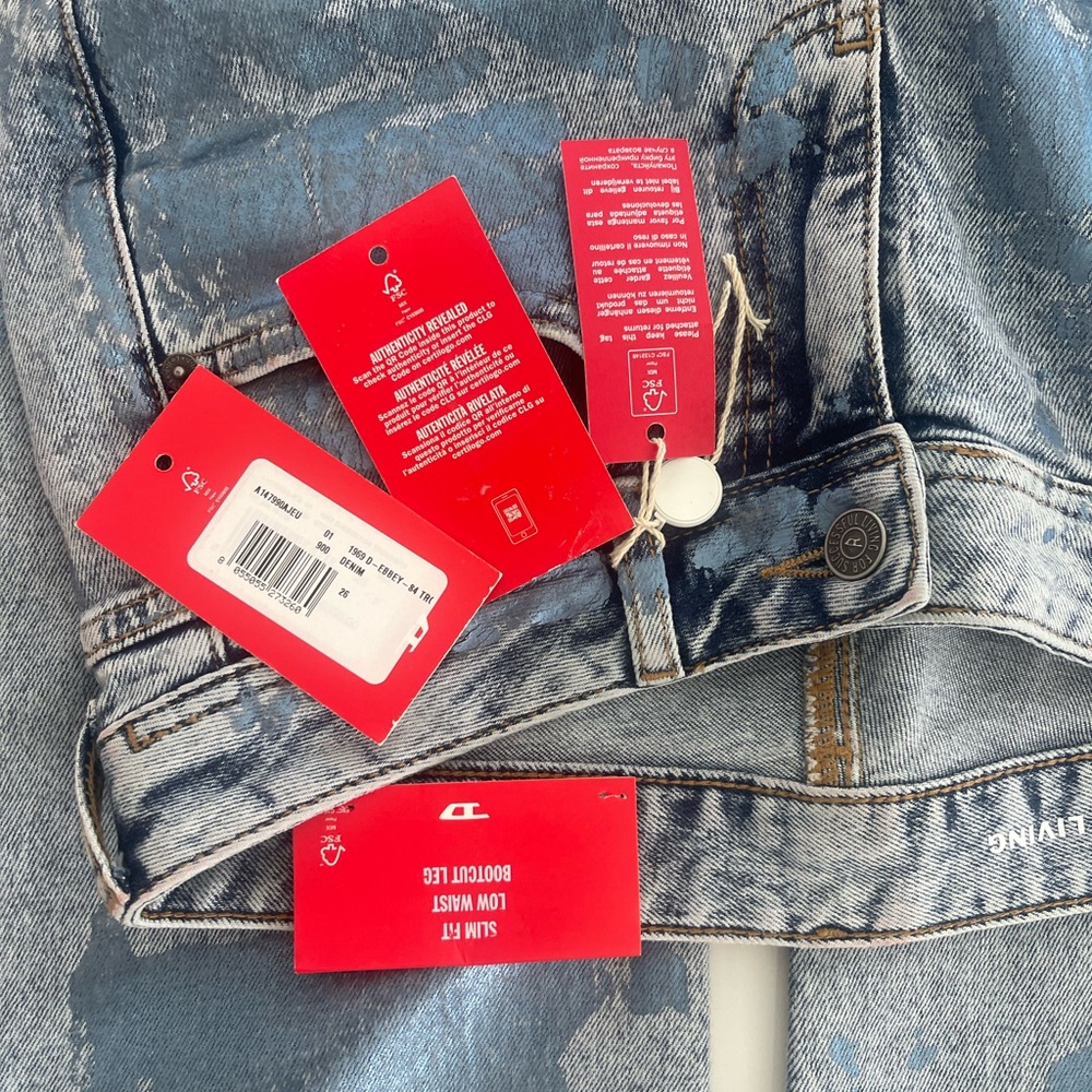 Diesel denim size 26 low rise bootcut stretch with metallic trim throughout.